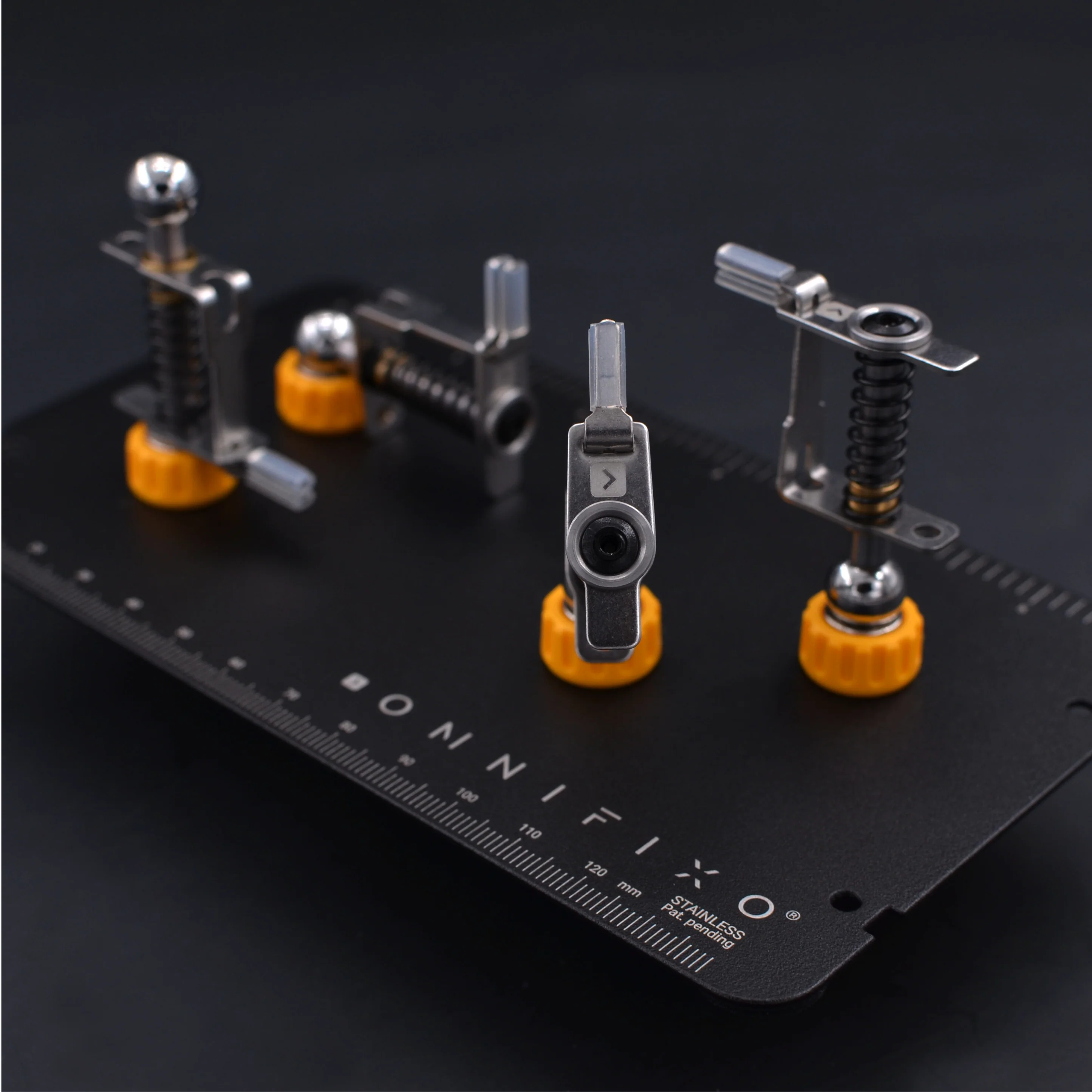 Picture of some Omnifixo clamps arranged for display. They are small clamps several centimetres tall.